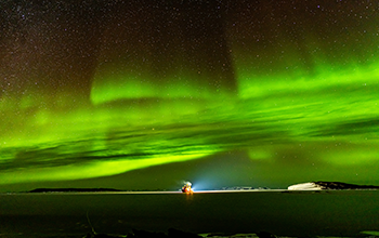 R/V Nathaniel B. Palmer at Davis Station anchorage with aurora australis light show overhead